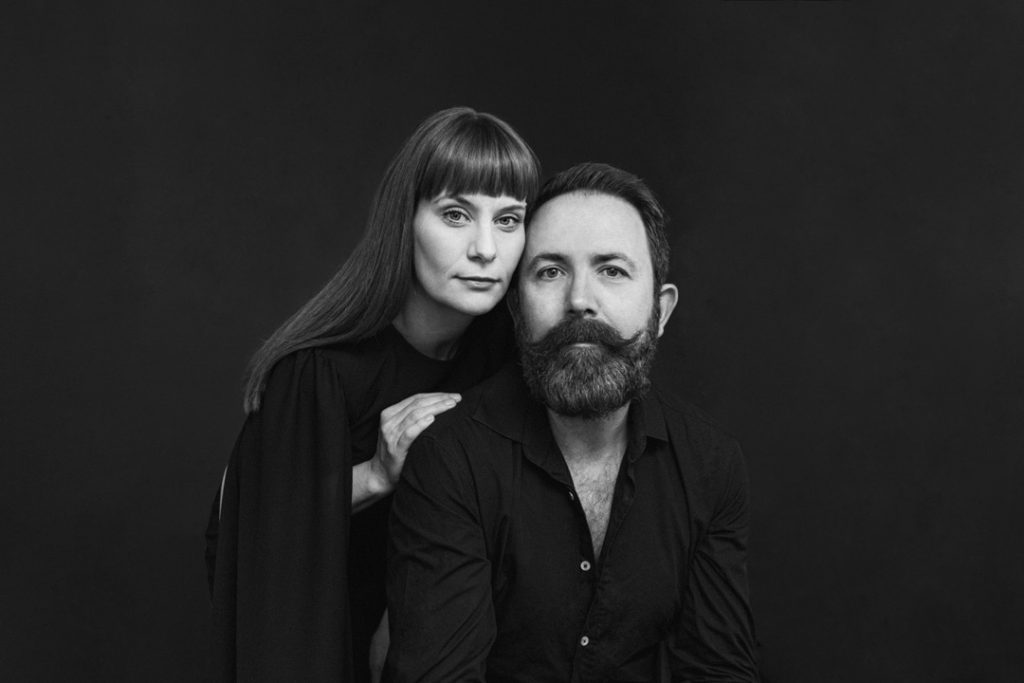 A man and woman posing for a their profile picture.